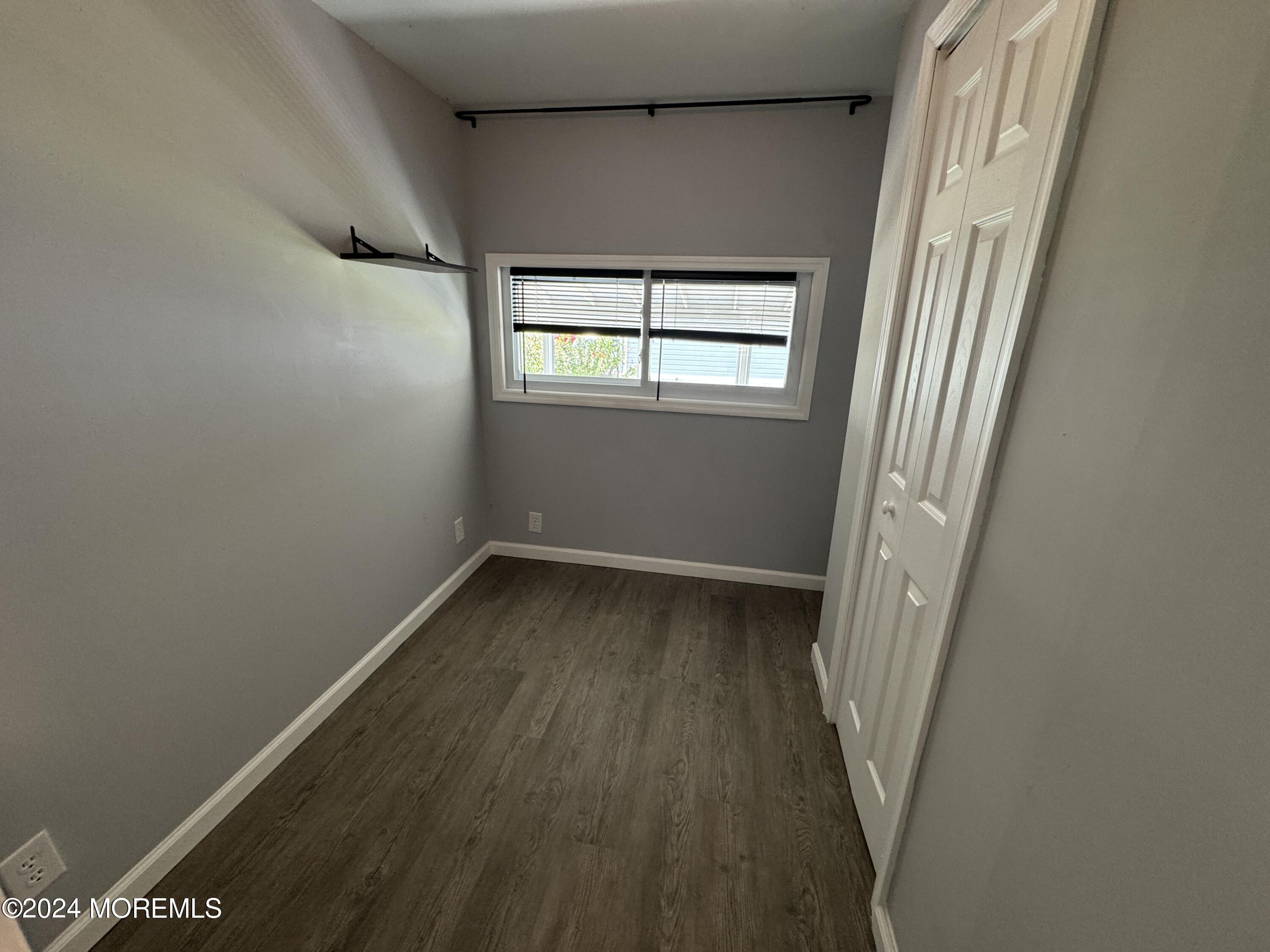 422 4th Street Jackson, NJ 08527 - Photo 12 of 17 a view of a hallway with wooden floor and a window
