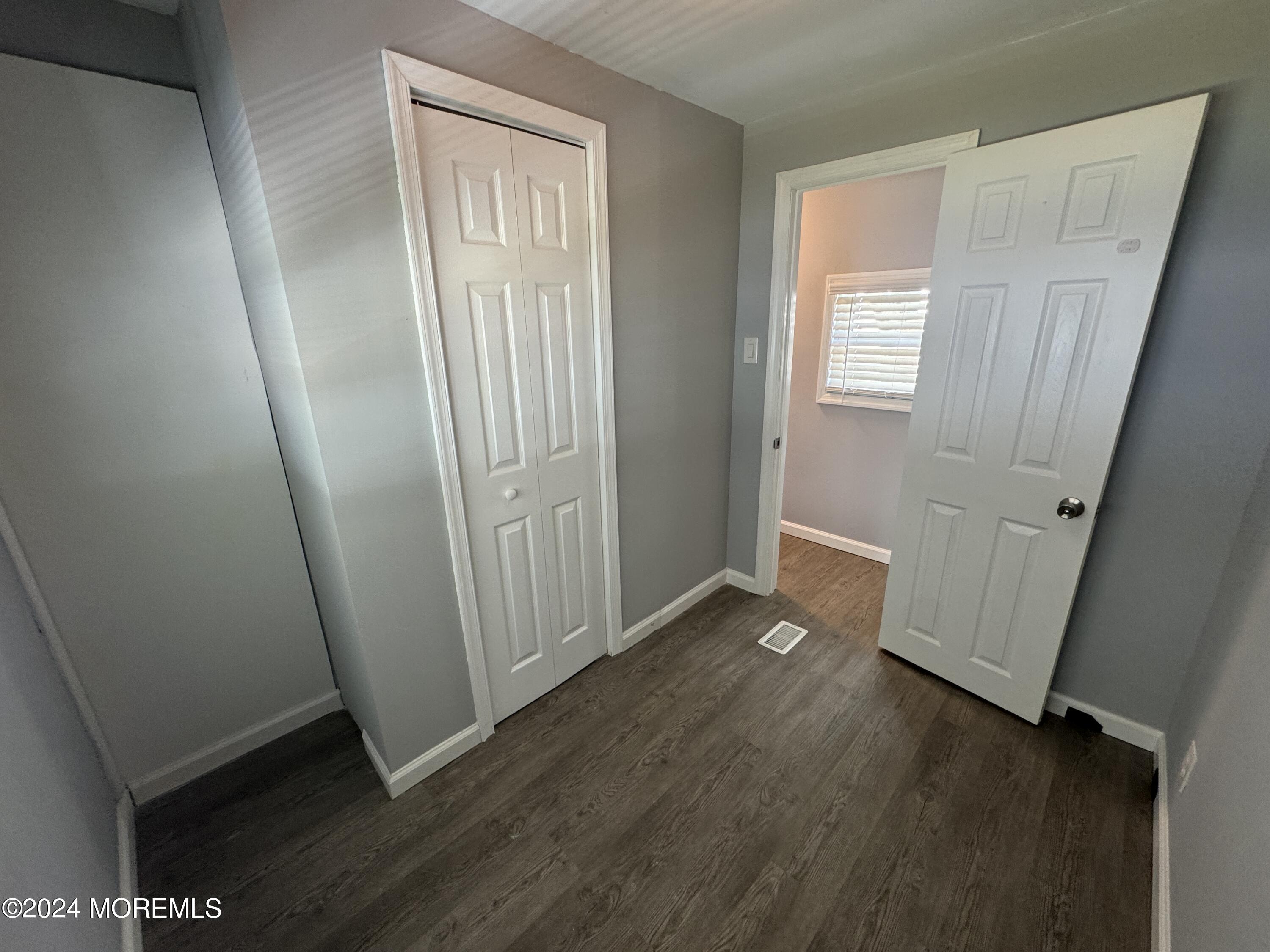 422 4th Street Jackson, NJ 08527 - Photo 13 of 17 an empty room with wooden floor and window