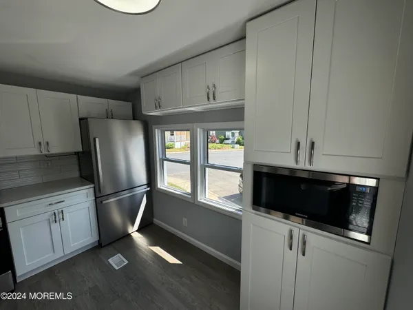 a kitchen with stainless steel appliances a stove a microwave and a refrigerator