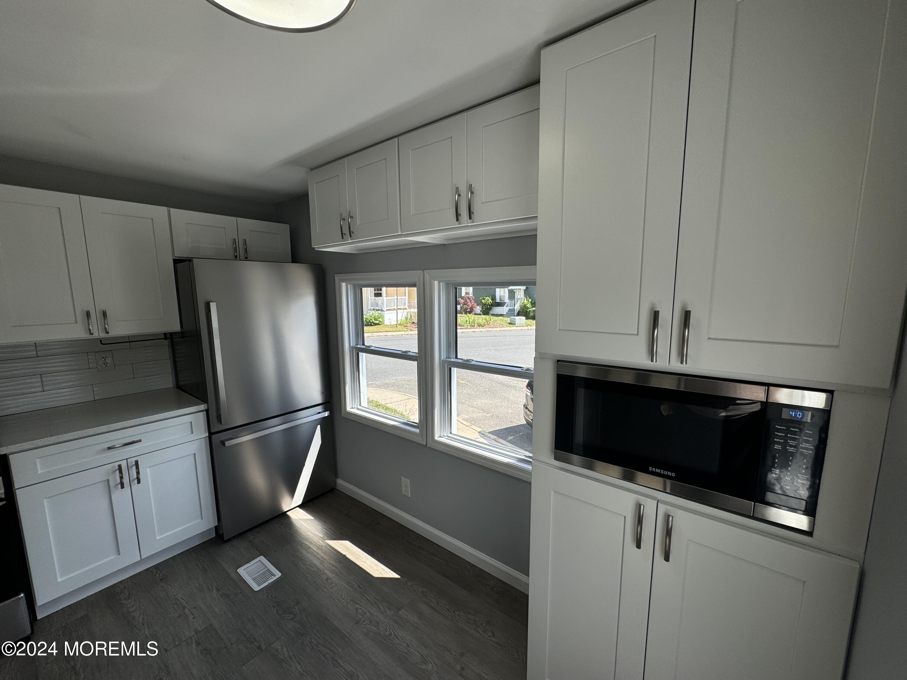 422 4th Street Jackson, NJ 08527 - Photo 3 of 17 a kitchen with stainless steel appliances a stove a microwave and a refrigerator