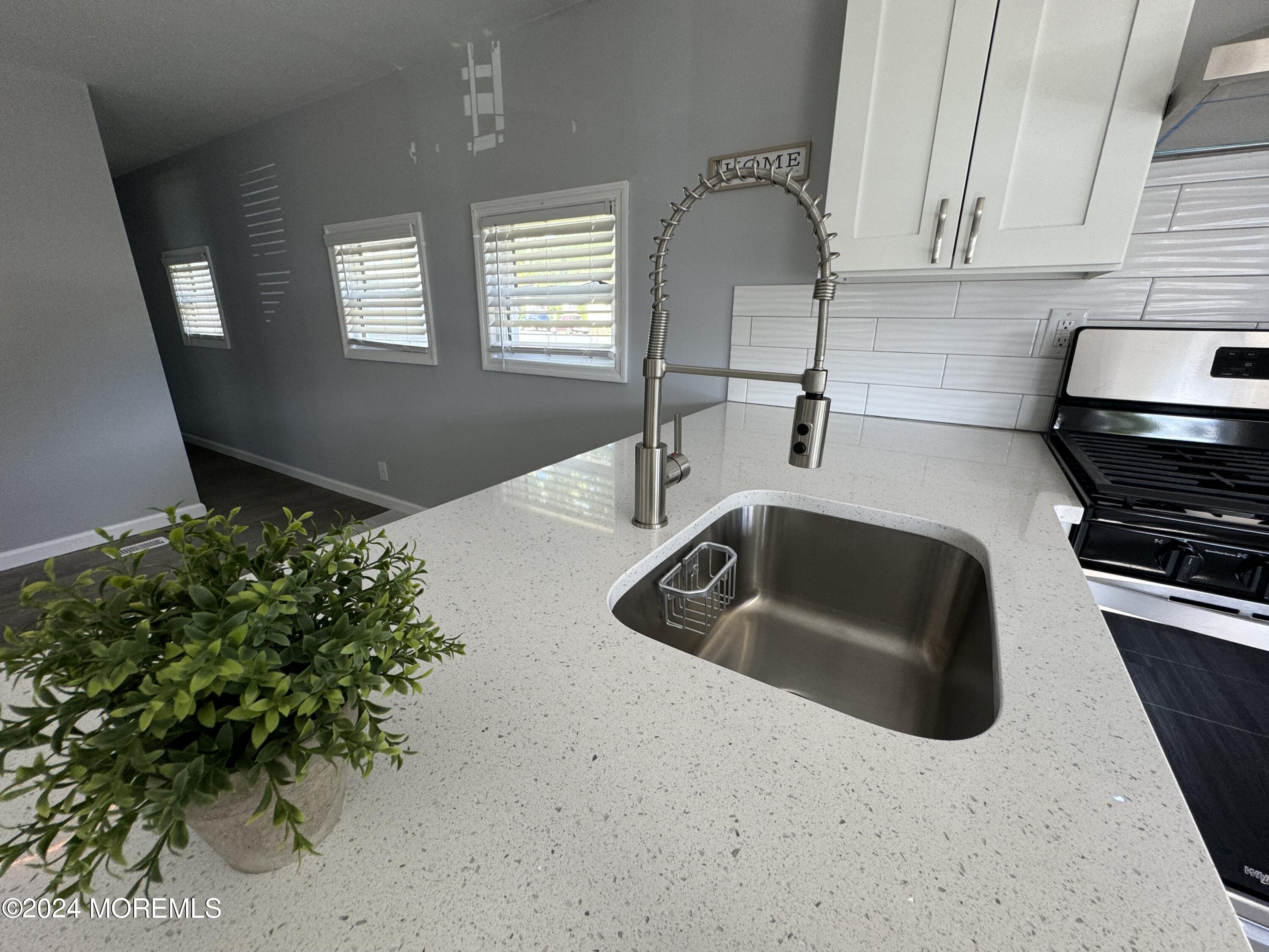 422 4th Street Jackson, NJ 08527 - Photo 7 of 17 a kitchen with granite countertop a sink and a stove
