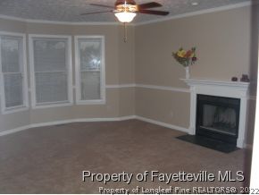 4938 Black Bridge Road Parkton, NC 28371 - Photo 11 of 17 a view of an empty room with a fireplace