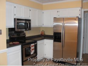 4938 Black Bridge Road Parkton, NC 28371 - Photo 3 of 17 a kitchen with a refrigerator and a stove