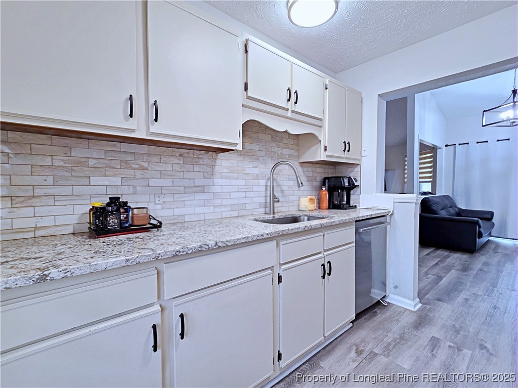 5309 Tory Hill Road Hope Mills, NC 28348 - Photo 13 of 45 a kitchen with stainless steel appliances granite countertop white cabinets a sink and dishwasher