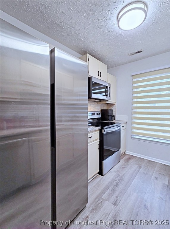 5309 Tory Hill Road Hope Mills, NC 28348 - Photo 16 of 45 a kitchen with a refrigerator and a stove