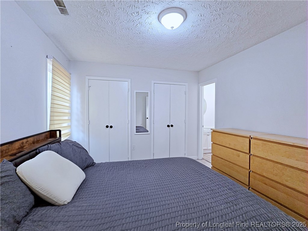 5309 Tory Hill Road Hope Mills, NC 28348 - Photo 20 of 45 a bedroom with a bed and a dresser