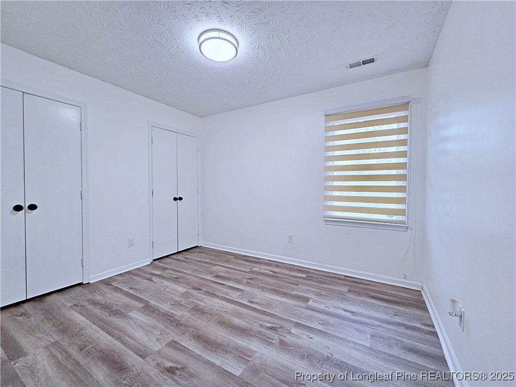 5309 Tory Hill Road Hope Mills, NC 28348 - Photo 24 of 45 a view of an empty room with wooden floor and a window