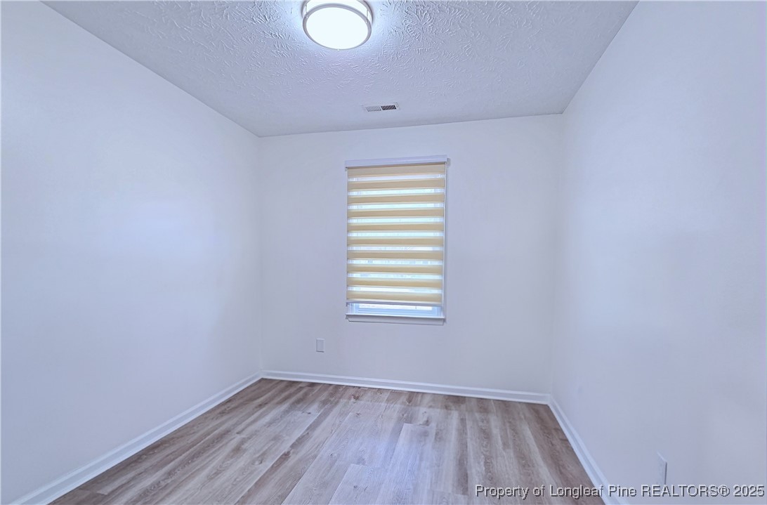 5309 Tory Hill Road Hope Mills, NC 28348 - Photo 30 of 45 a view of an empty room with wooden floor and a window