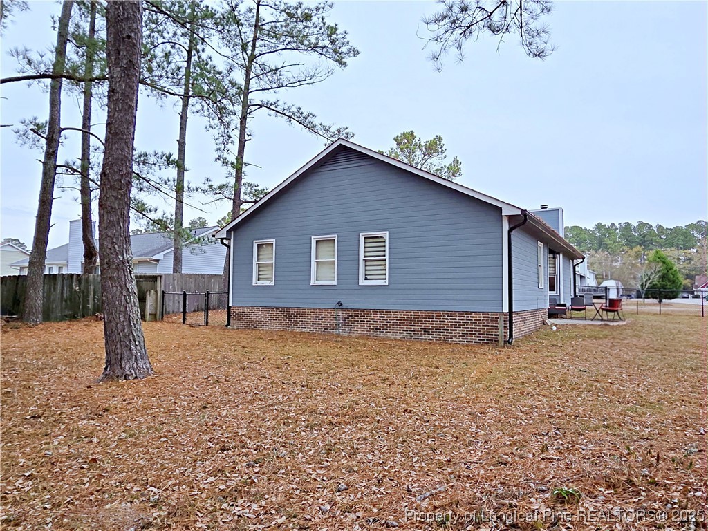5309 Tory Hill Road Hope Mills, NC 28348 - Photo 42 of 45 a house that has a tree in front of it