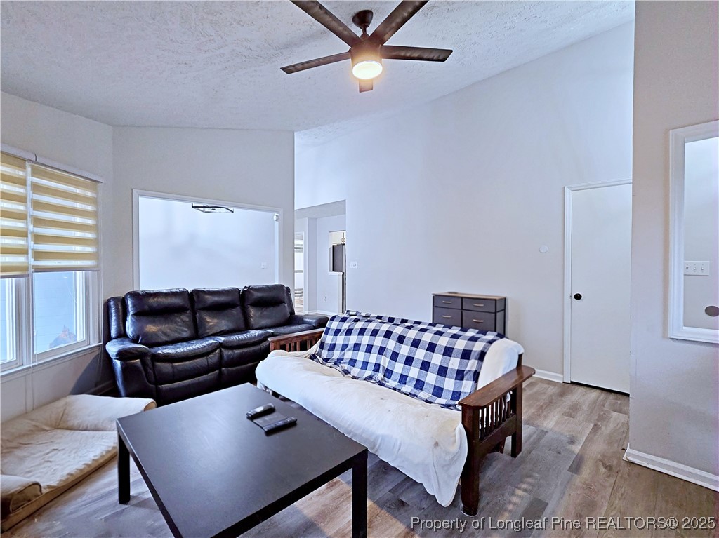 5309 Tory Hill Road Hope Mills, NC 28348 - Photo 8 of 45 a living room with a couch and a table with wooden floor