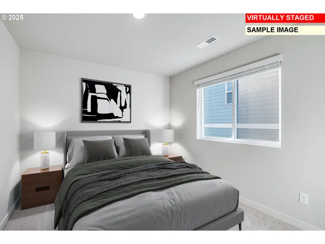 a bedroom with a bed and a painting on the wall