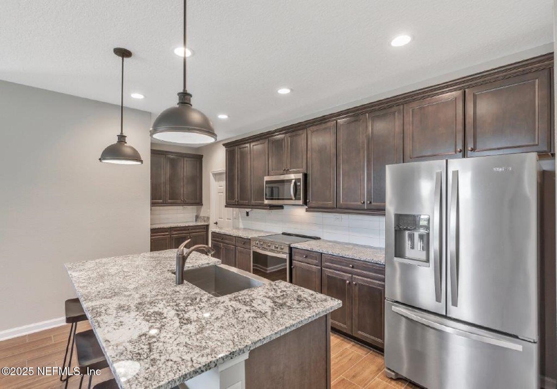 1000 Brk Frst Drive St. Augustine, FL 32092 - Photo 5 of 14 a kitchen with kitchen island a counter top space appliances and cabinets