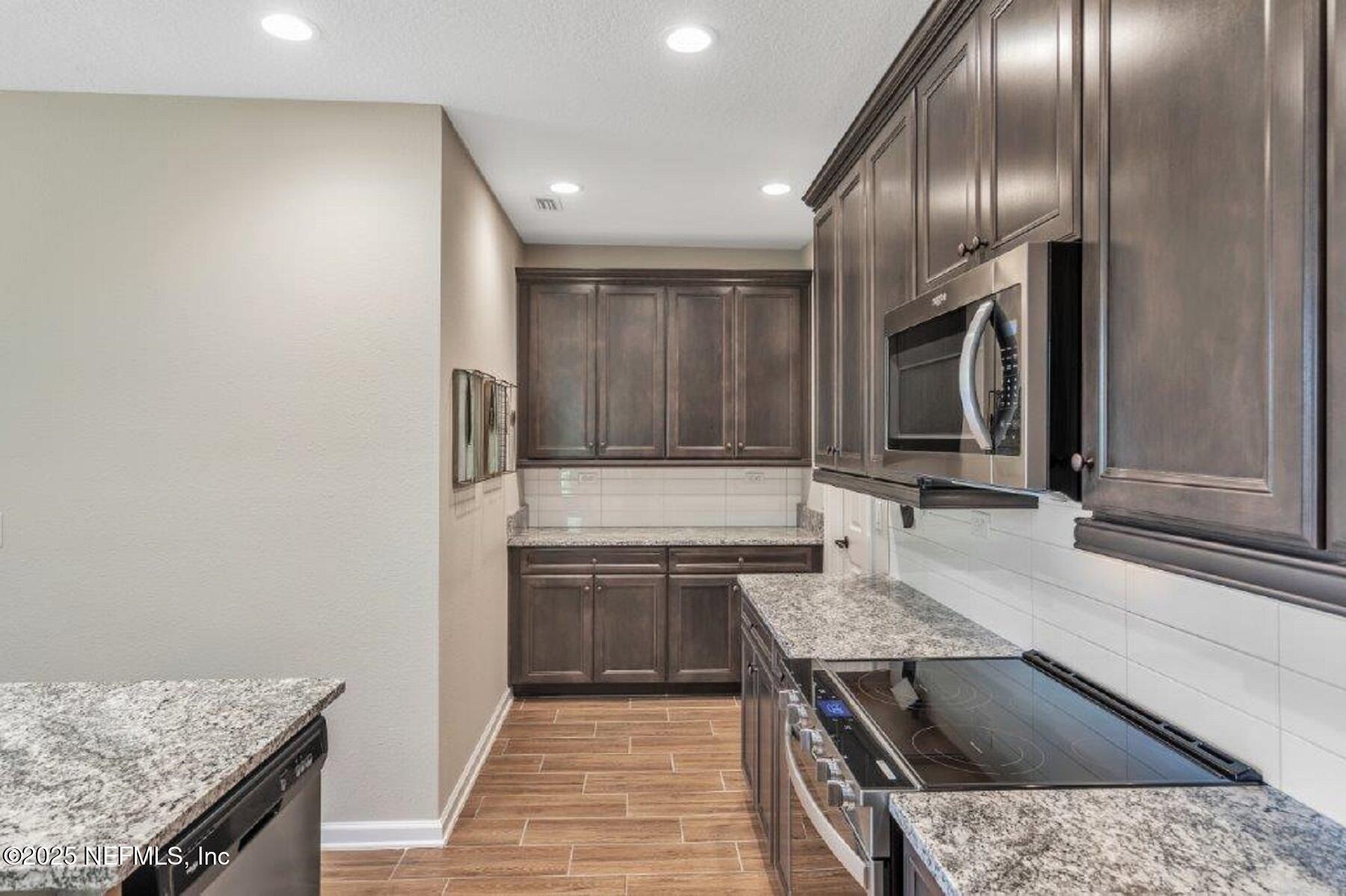 1000 Brk Frst Drive St. Augustine, FL 32092 - Photo 6 of 14 an open kitchen with granite countertop a sink and stove