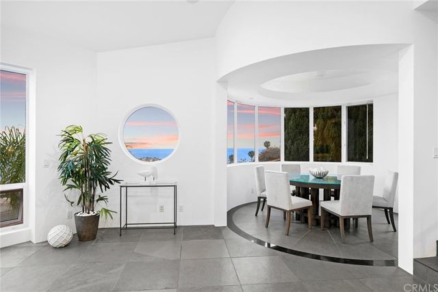 a bedroom with a bed a fireplace and a flat screen tv