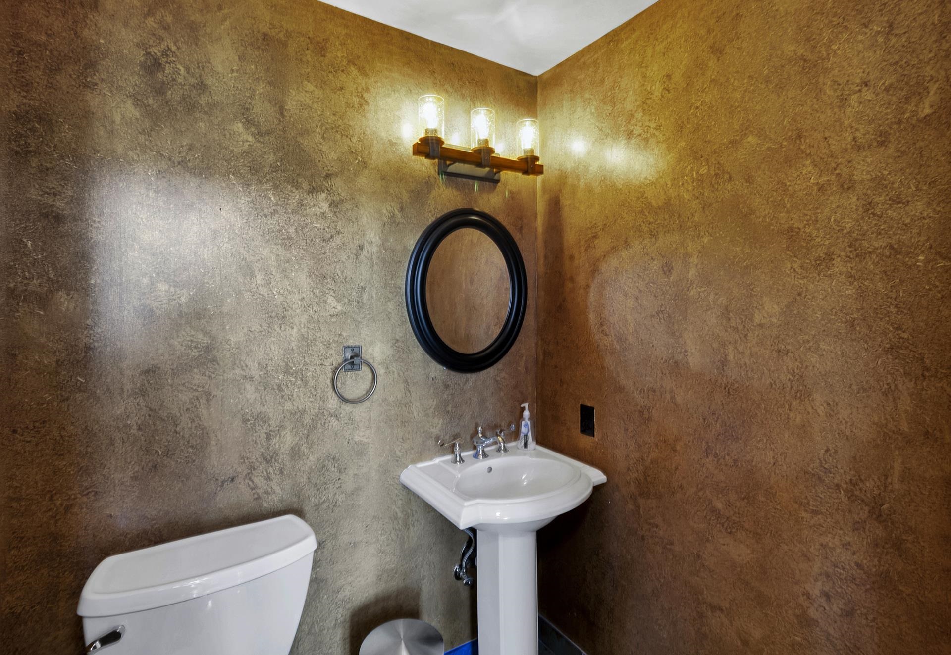 981 25 Road Grand Junction, CO 81505 - Photo 16 of 42 a bathroom with a toilet sink and mirror
