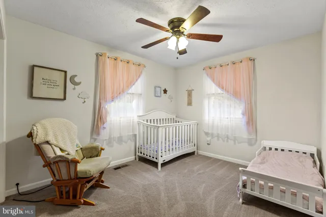 a bedroom with a bed and a chair