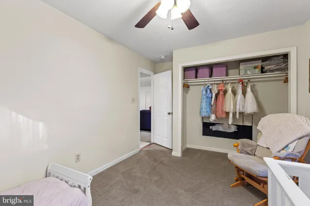a view of a livingroom with furniture and a ceiling fan