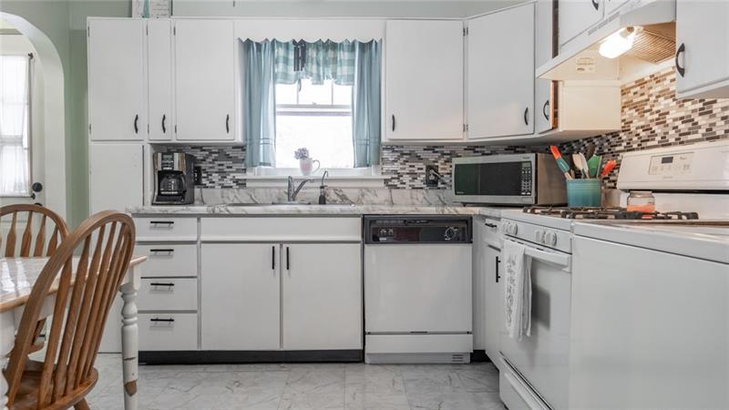 49 George Jr Road Grove City, PA 16127 - Photo 8 of 25 Darling 11x11 eat in kitchen with modern backsplash overlooks the peaceful backyard