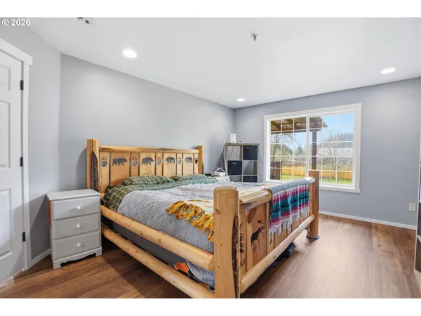 a bedroom with a bed next to a window