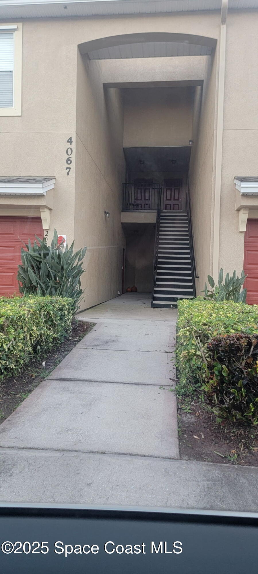 4067 Meander Place, Unit 204 Rockledge, FL 32955 - Photo 2 of 17 a living room with a fireplace and potted plants