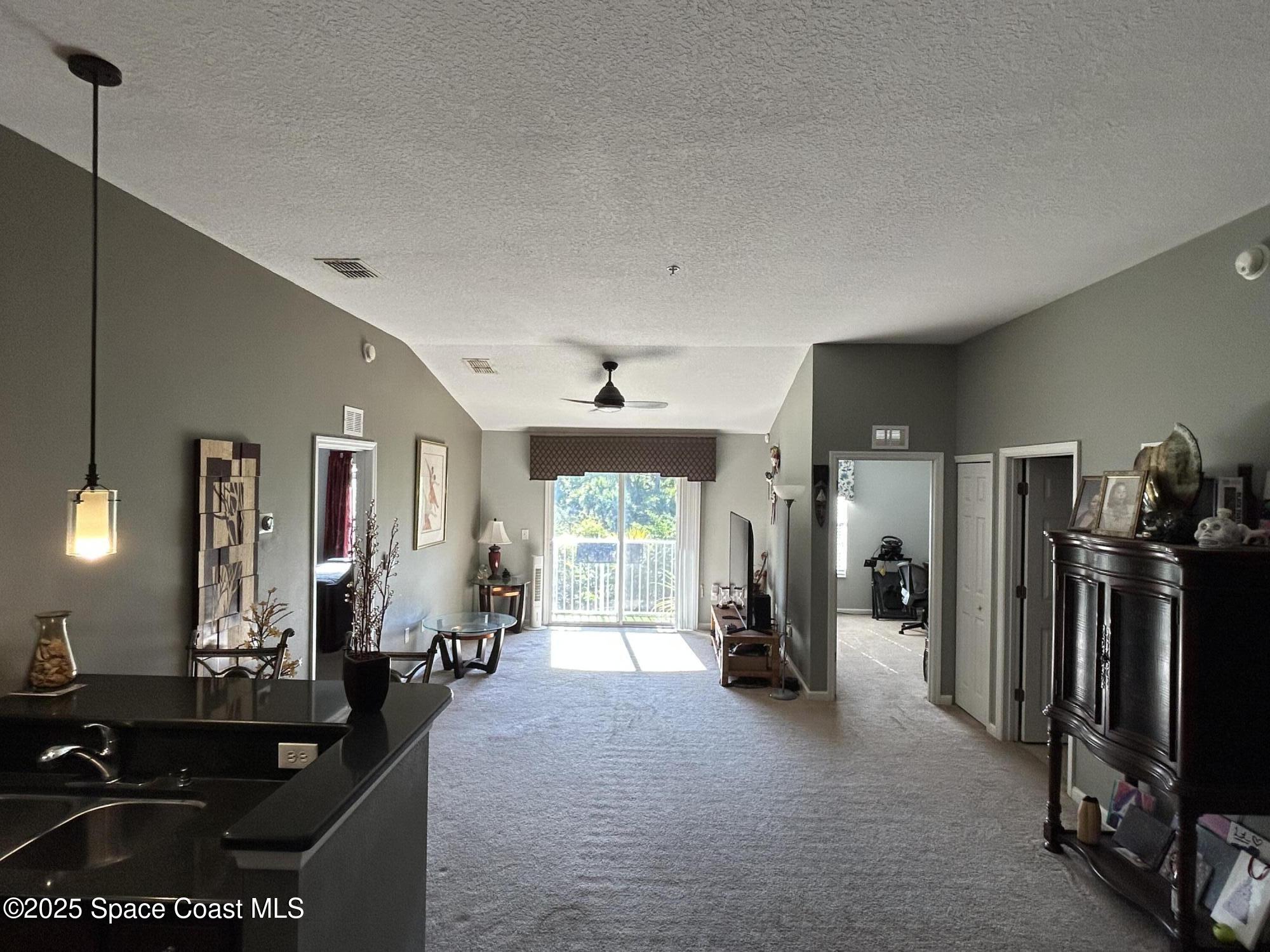 4067 Meander Place, Unit 204 Rockledge, FL 32955 - Photo 7 of 17 a living room with furniture a large window and gym equipment