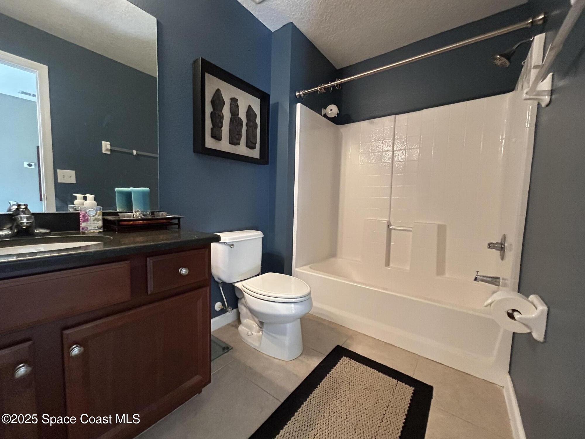4067 Meander Place, Unit 204 Rockledge, FL 32955 - Photo 8 of 17 a bathroom with a toilet a sink and a shower