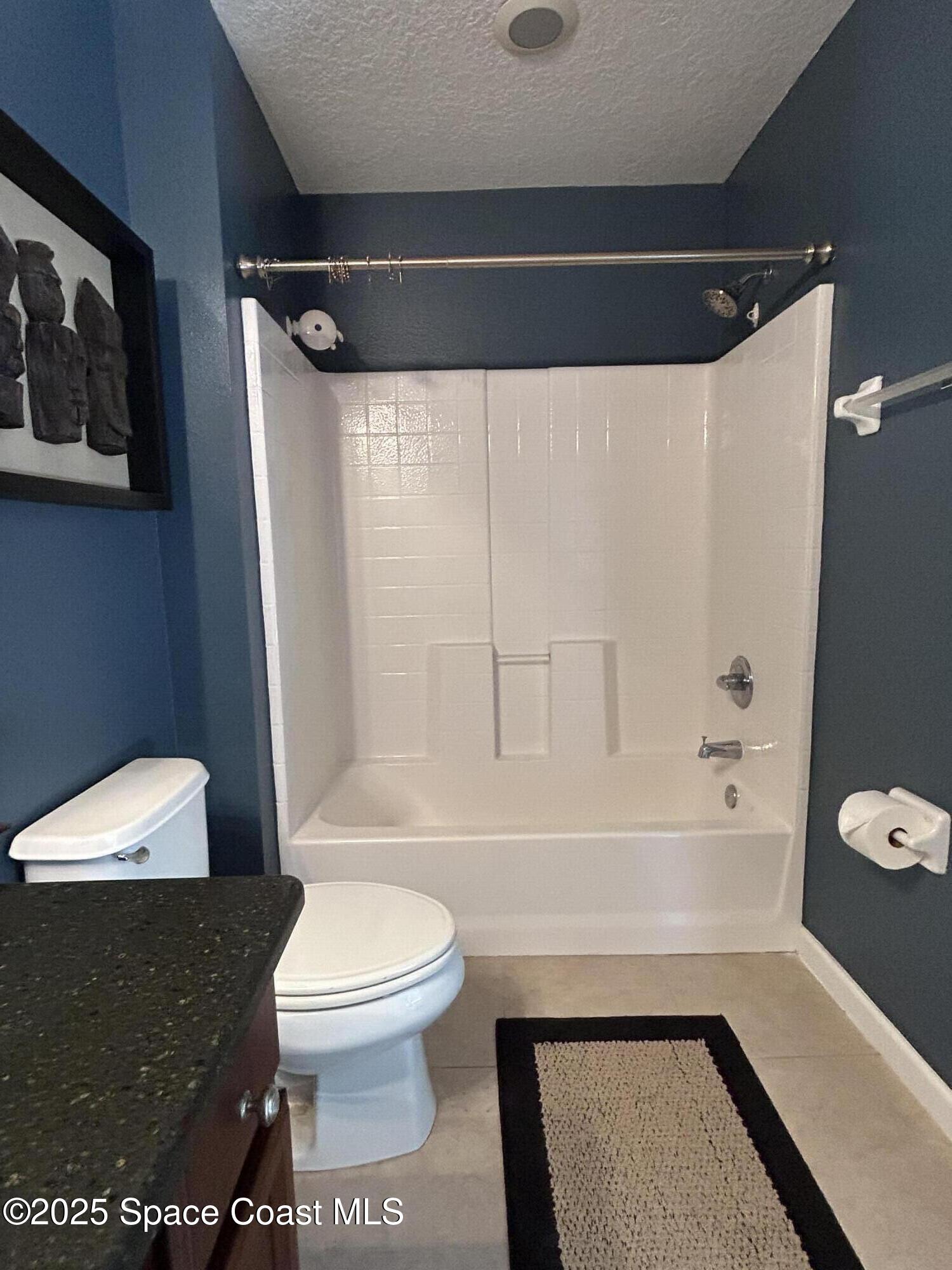 4067 Meander Place, Unit 204 Rockledge, FL 32955 - Photo 9 of 17 a bathroom with a toilet a sink and a bathtub