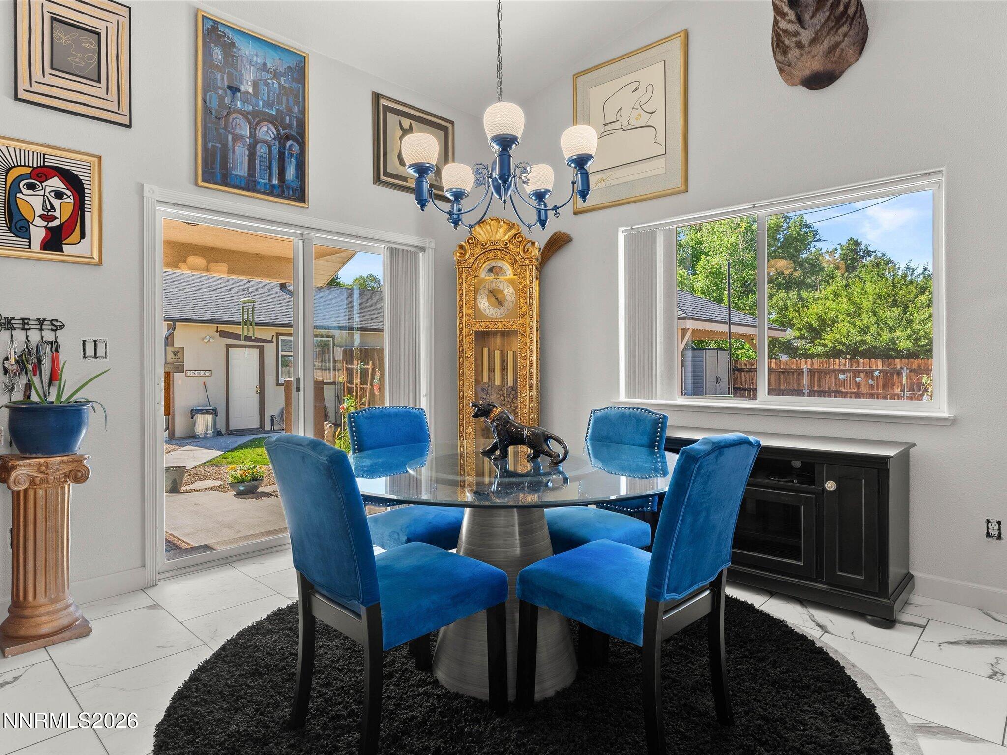 1080 Red Rock Road Fernley, NV 89408 - Photo 13 of 45 a view of a dining room with furniture a chandelier and a large window