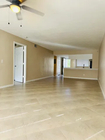 a view of a kitchen with stainless steel appliances a sink and cabinets