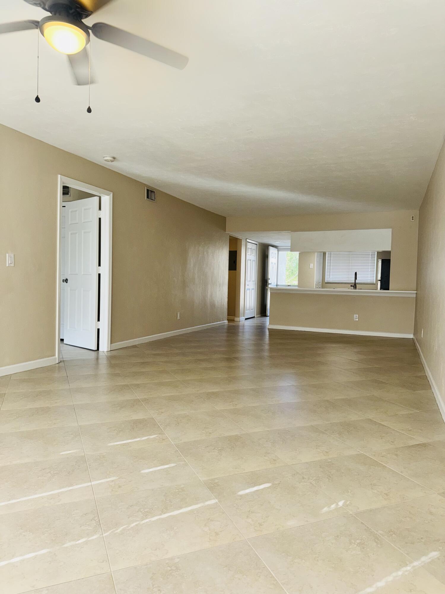 1708 Palm Beach Trace Drive Royal Palm Beach, FL 33411 - Photo 4 of 13 a view of an empty room with a window