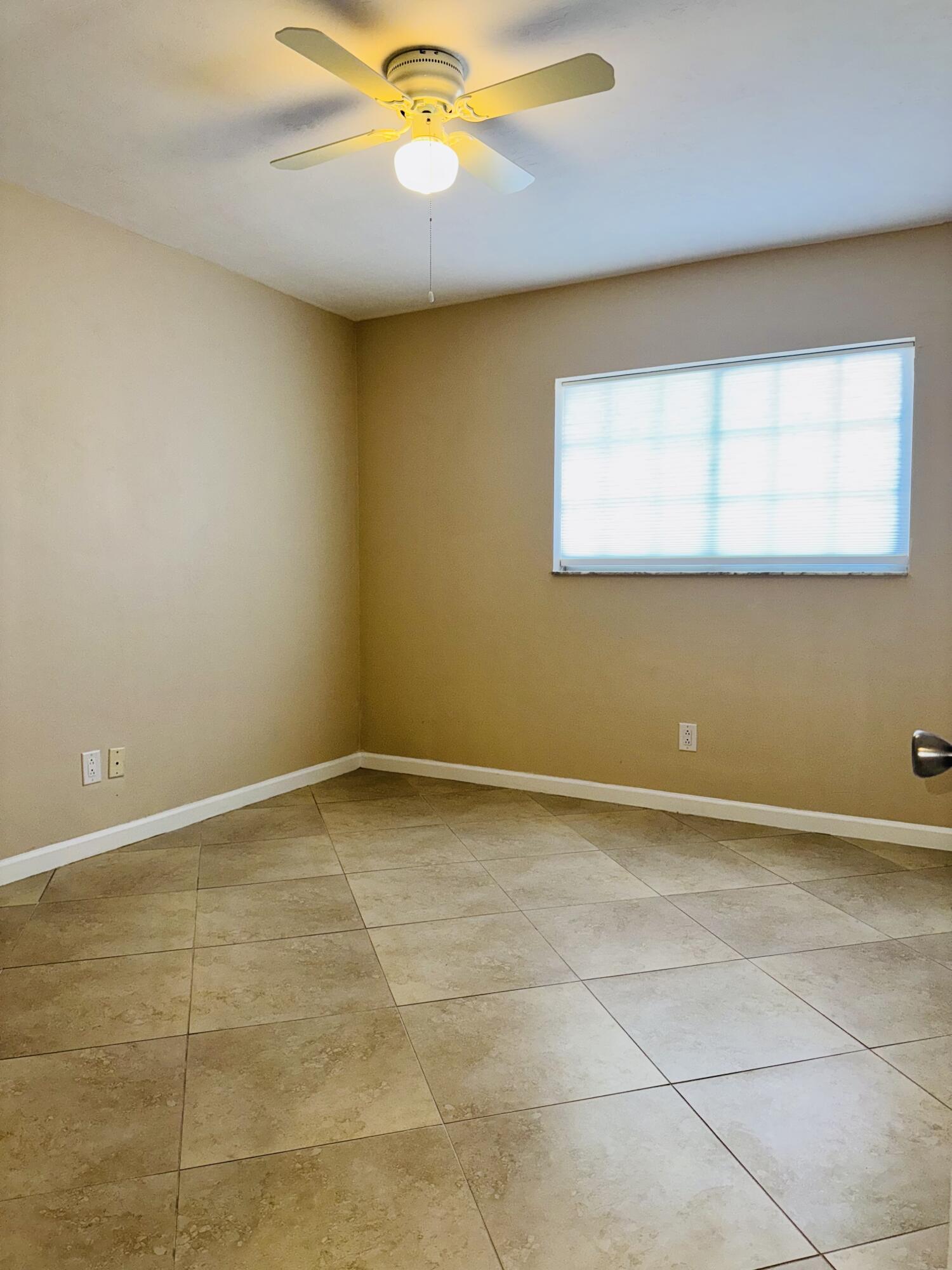 1708 Palm Beach Trace Drive Royal Palm Beach, FL 33411 - Photo 6 of 13 a view of an empty room with a window