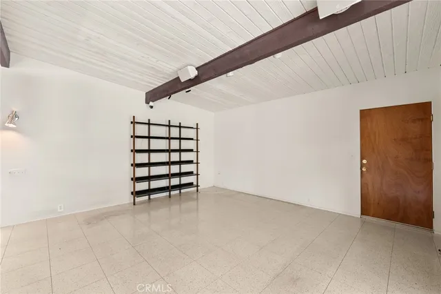 a view of a livingroom with an empty space and a fireplace