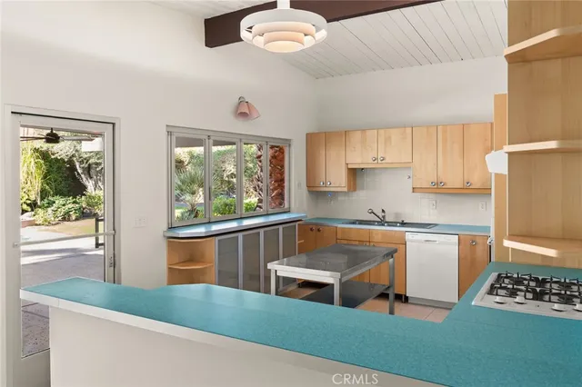 a kitchen with stainless steel appliances a stove a sink and a refrigerator