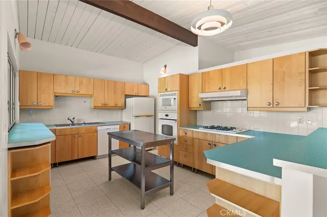 a kitchen with a stove a sink and a refrigerator