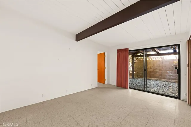 a view of a room with rug and a window