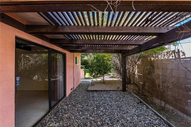a view of a house with backyard porch and sitting area