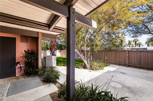 a backyard of a house with plants and trees