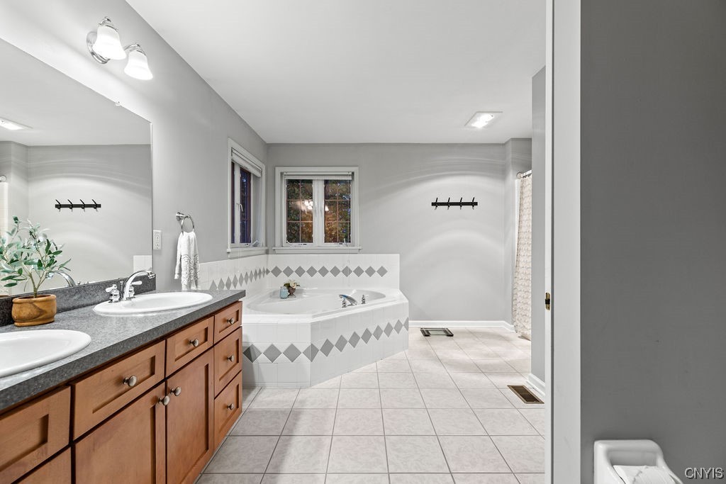 138 Eagle Crest Drive Camillus, NY 13031 - Photo 44 of 50 Large primary bath with tile flooring, dual vaniti