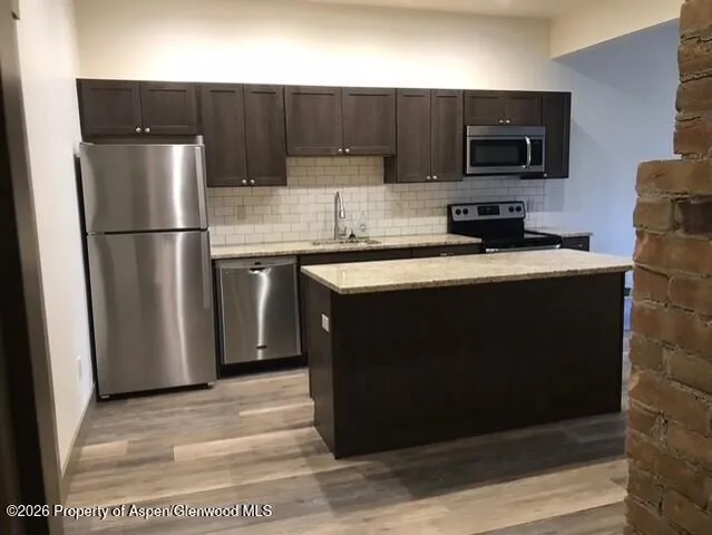 a kitchen with a sink and a refrigerator
