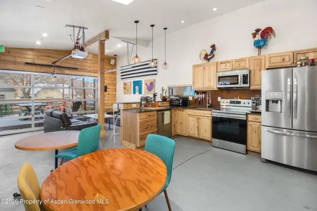 a kitchen with stainless steel appliances granite countertop a sink a stove and a refrigerator