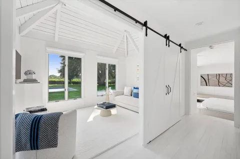 a bedroom with a large bed and a large window