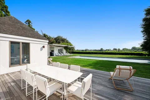 a view of yard with deck and outdoor seating