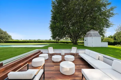 a green field with some trees in the background