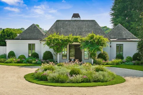 a front view of a house with garden