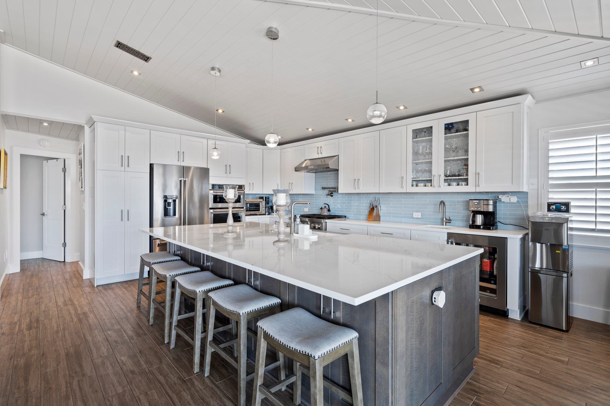 5497 Pelican Way St. Augustine, FL 32080 - Photo 16 of 49 a kitchen with a dining table chairs and wooden floor