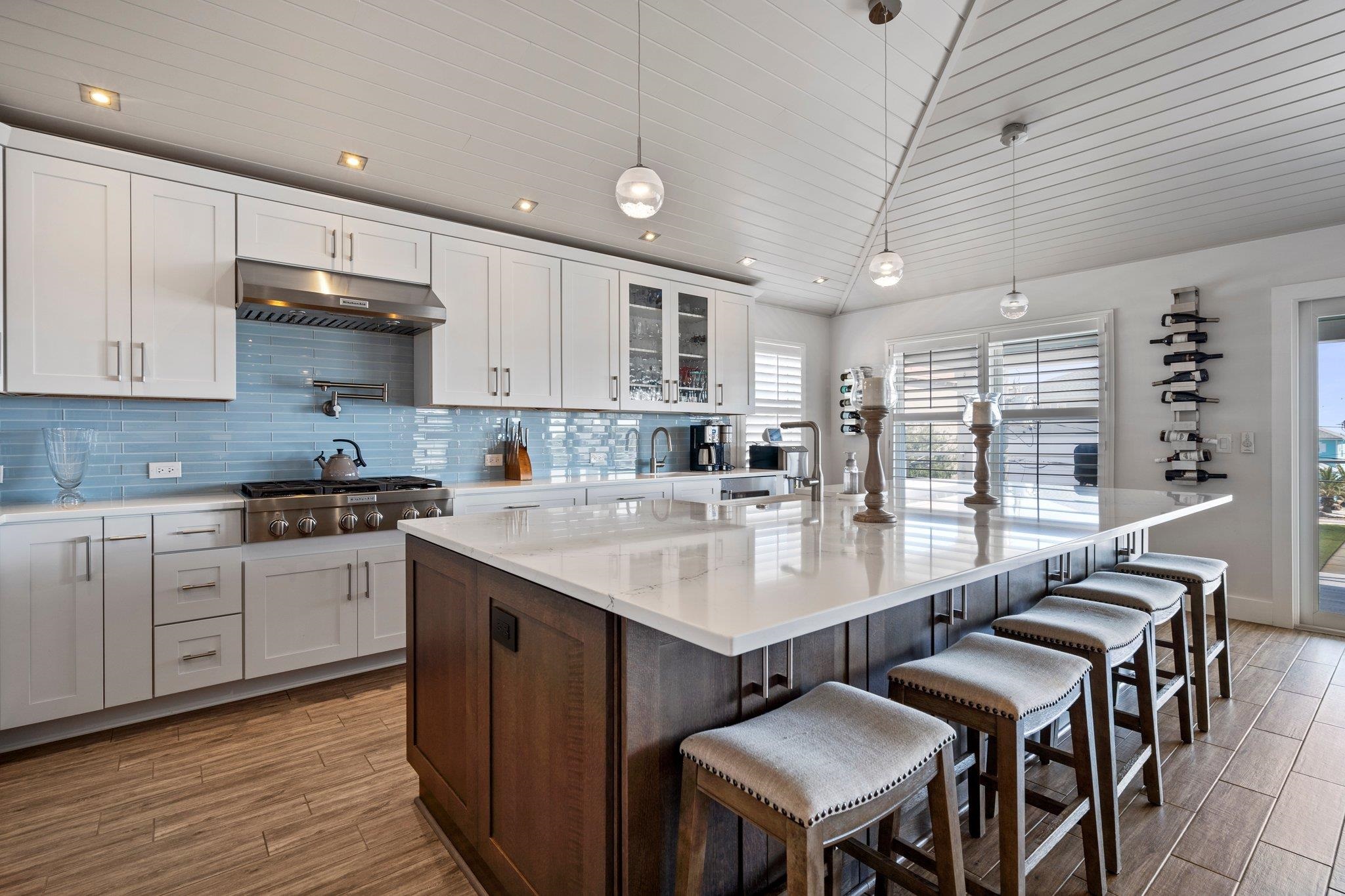5497 Pelican Way St. Augustine, FL 32080 - Photo 19 of 49 a kitchen with stainless steel appliances granite countertop a table chairs sink and cabinets