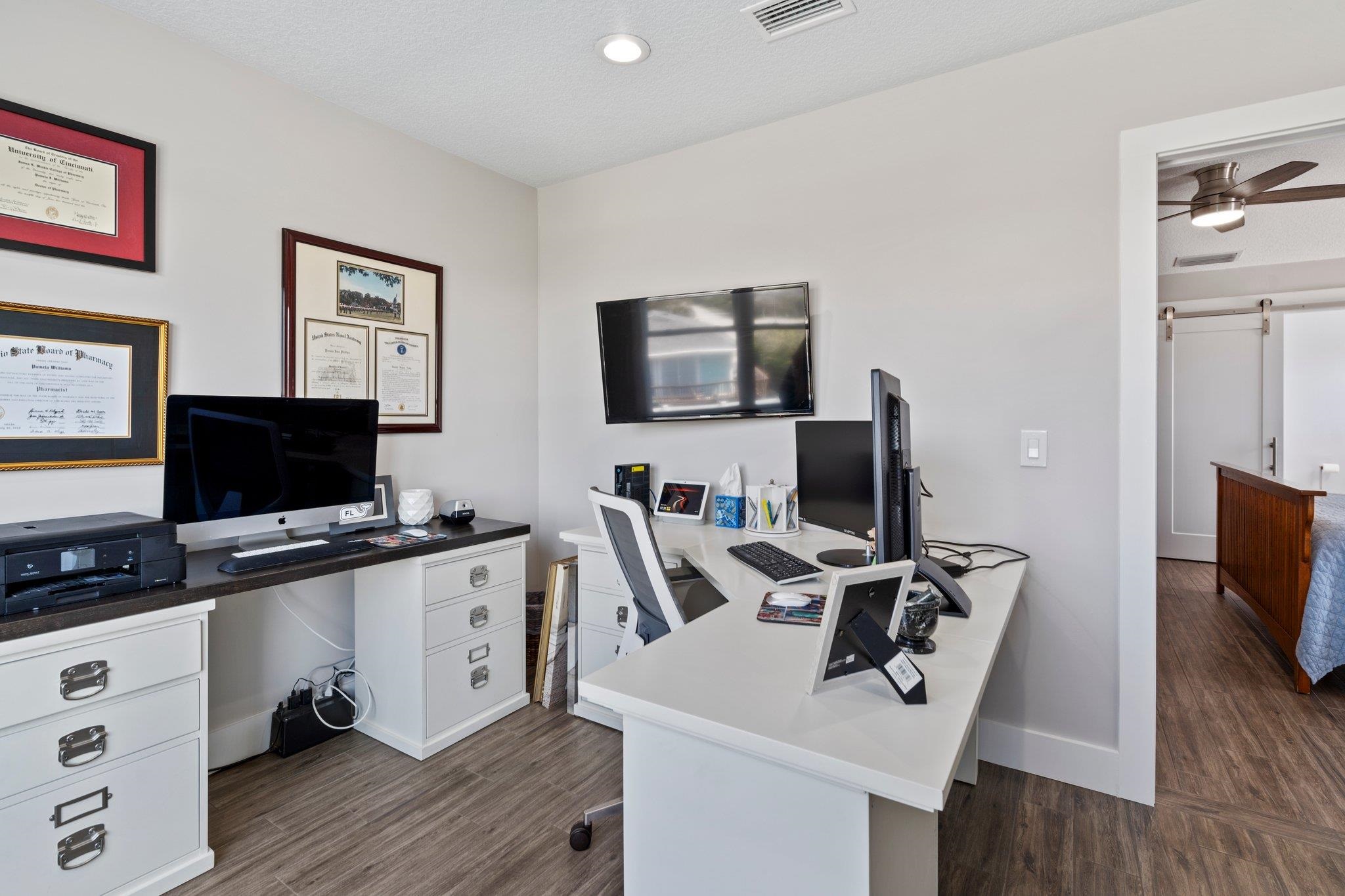 5497 Pelican Way St. Augustine, FL 32080 - Photo 26 of 49 a view of a workspace with furniture and flat screen tv