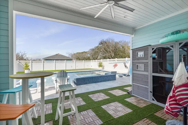 a view of a porch with a table and chairs
