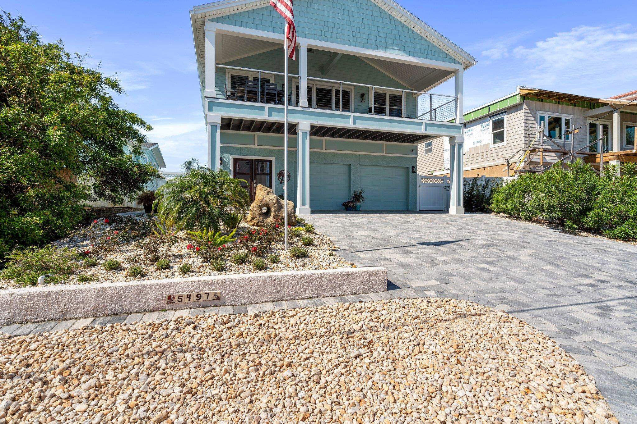 5497 Pelican Way St. Augustine, FL 32080 - Photo 7 of 49 a front view of a house with a yard and a garage