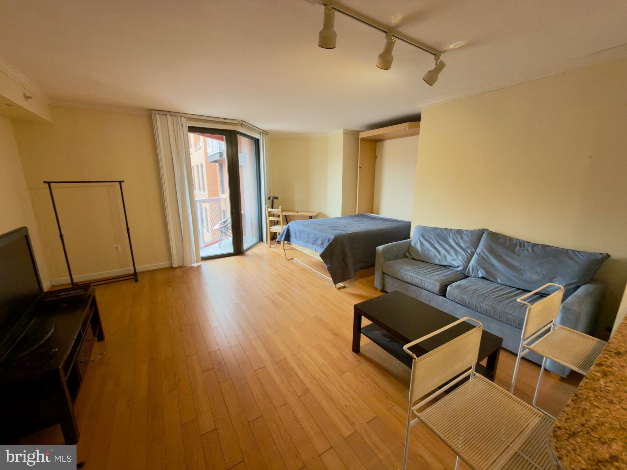 631 D Street Northwest, Unit 1038 Washington, DC 20004 - Photo 17 of 56 a living room with furniture and a flat screen tv